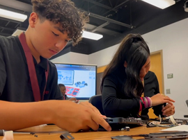  Students disassembling a computer.